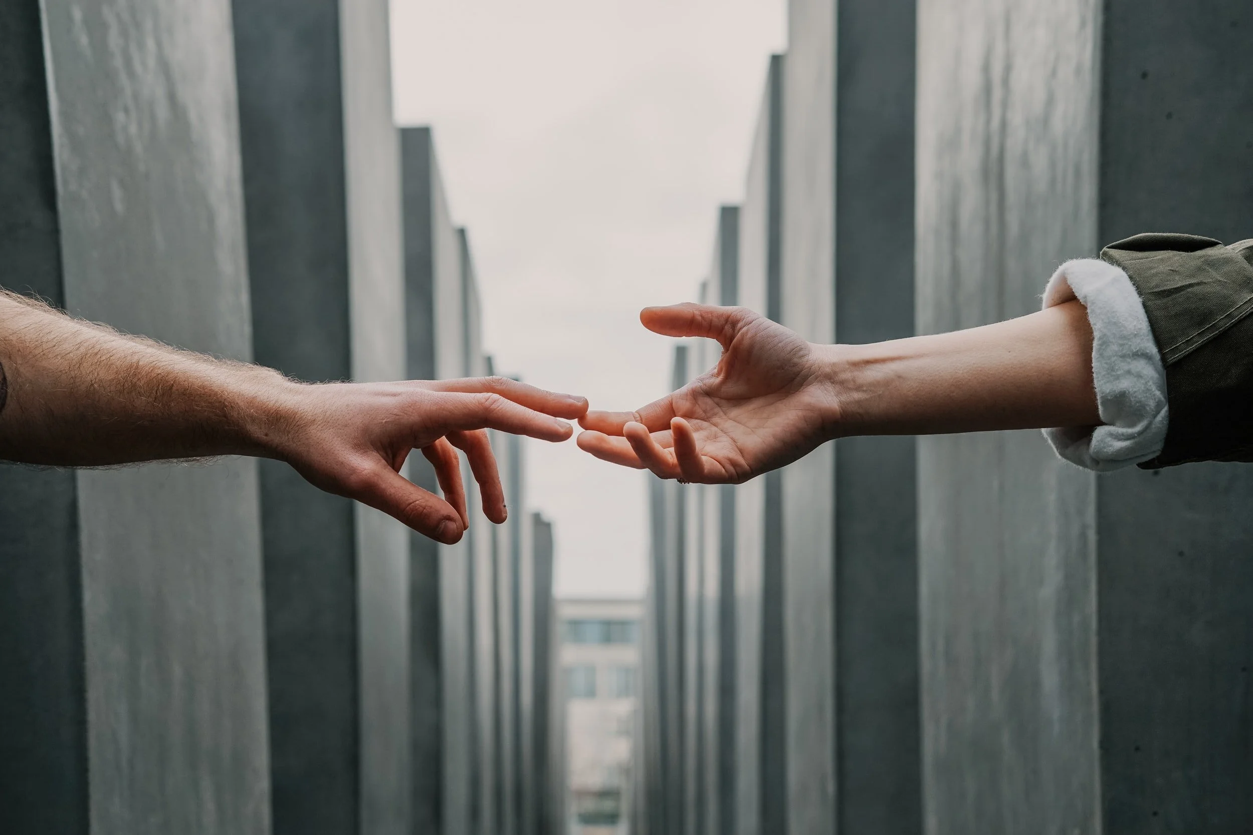 Two hands reaching toward each other
